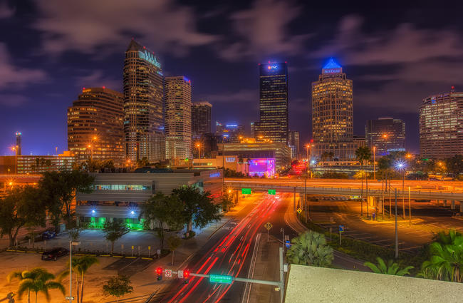 Downtown tampa at dusk with streaking reds lights from car tailights.