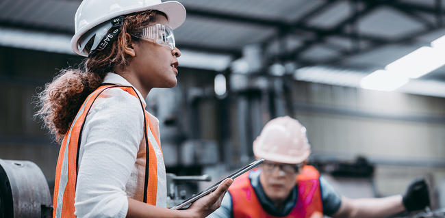 2 employees wearing hardhats in factory