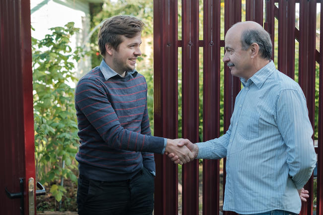 Neighbors shaking hands