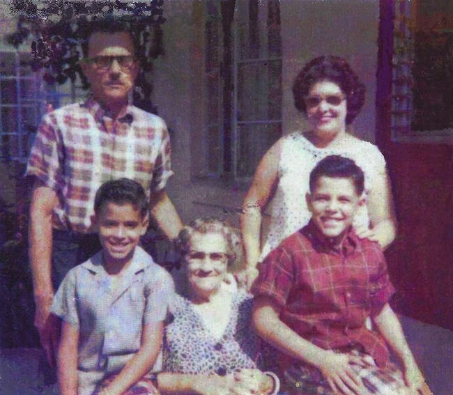 This is my grandfather, Manuel Martinez Sr., my grandmother Amada Martinez,  my uncle, Jorge Martinez, my great-grandmother, Nicasia Crespo and my dad, Manuel Martinez Jr. This photo was taken in Robles Park Village, just a few months after they fled Cuba.