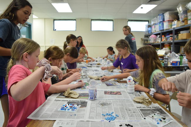 Kids working on project with adults supervising