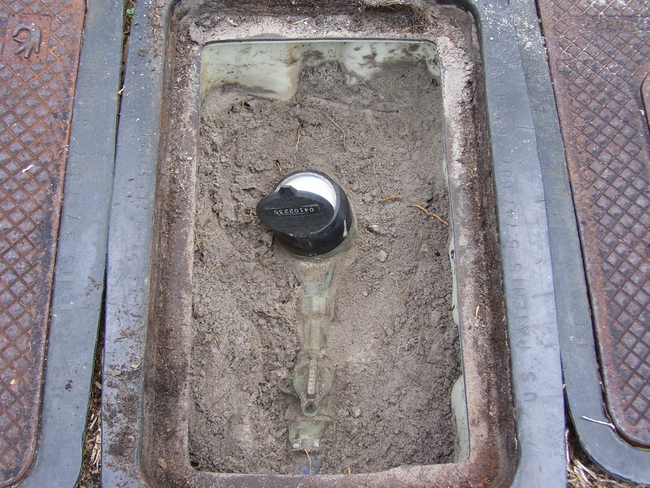 Photo of a water meter in a meter box.