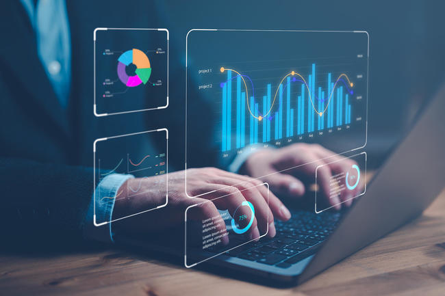 Hands at keyboard with charts