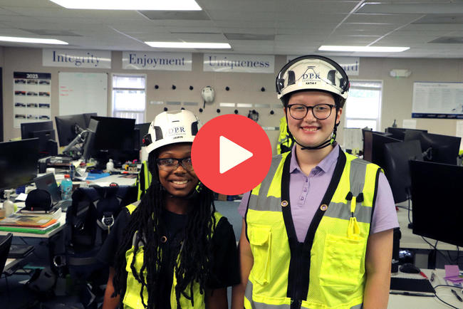 Play video - two interns wearing hardhats