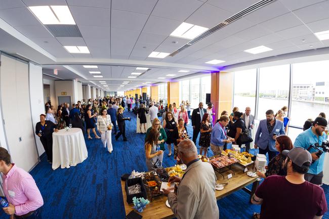 Waterfront meeting rooms filled with people during an event