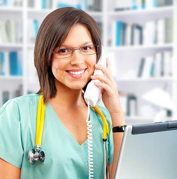 Nurse at computer on the phone