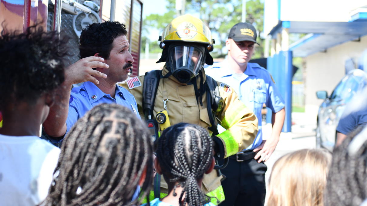 Firefighter talking to school group