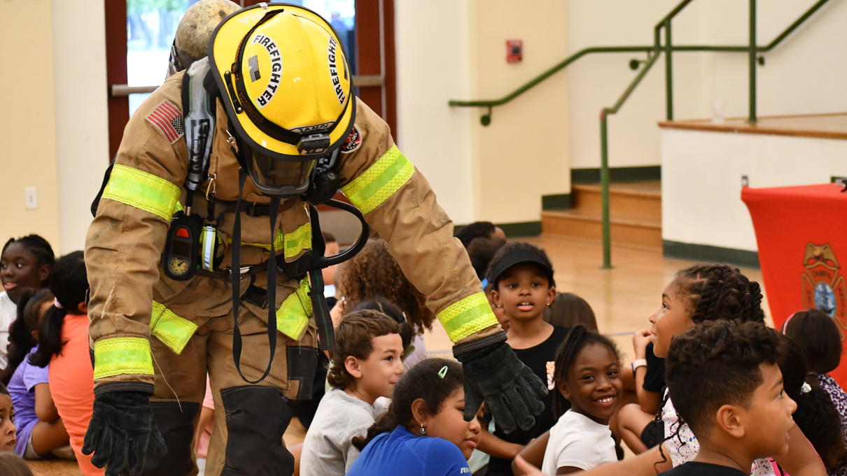 Firefighter engaging with students